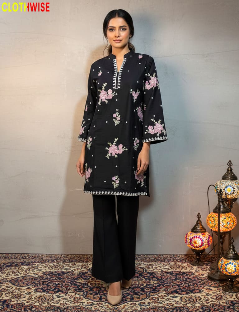 Woman wearing a black floral embroidered outfit with decorative lamps in the background