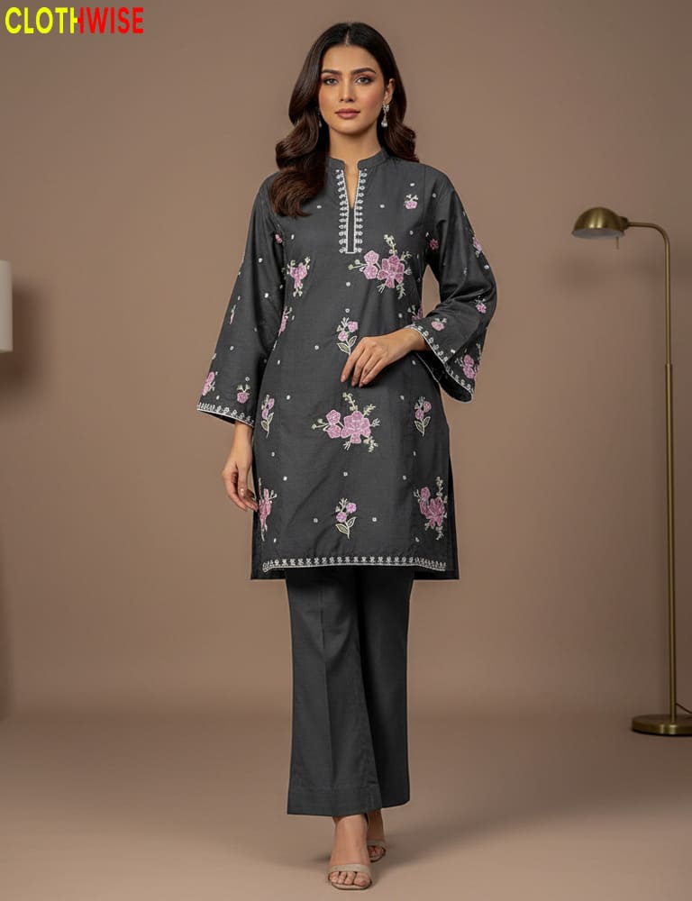 Woman wearing a dark gray traditional outfit with floral patterns on a brown background
