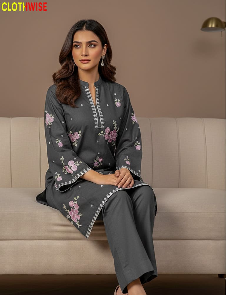 Woman wearing a gray embroidered outfit sitting on a beige couch with 'CLOTHWISE' branding.