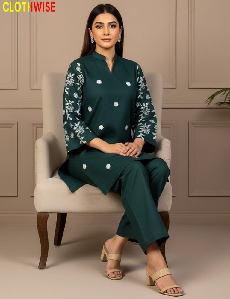 Woman sitting on a chair wearing a green outfit with floral patterns, brand 'CLOTHWISE' visible.