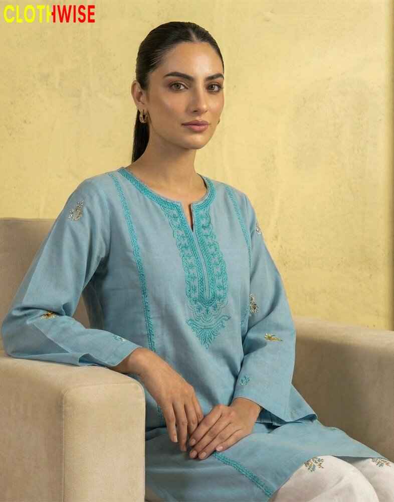 model wearing a embroidered suit sitting on sofa clothes by clothwise
