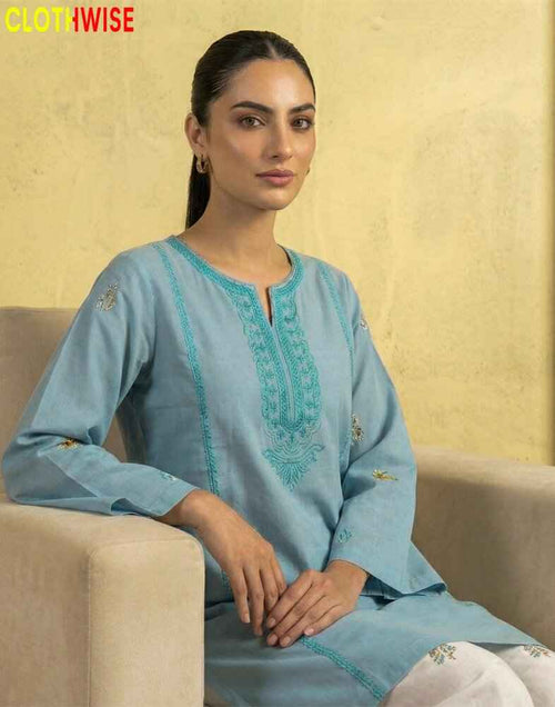 model wearing a embroidered suit sitting on sofa clothes by clothwise
