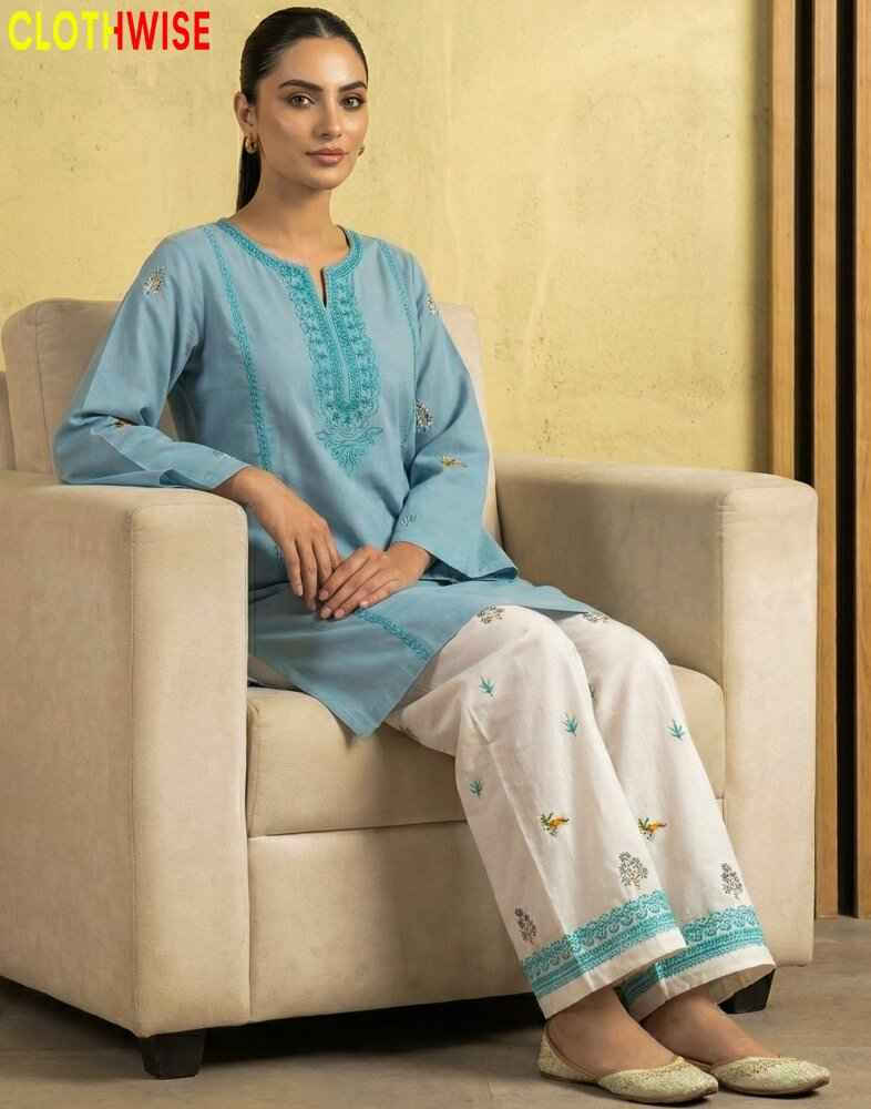 model wearing a embroidered suit sitting on sofa clothes by clothwise
