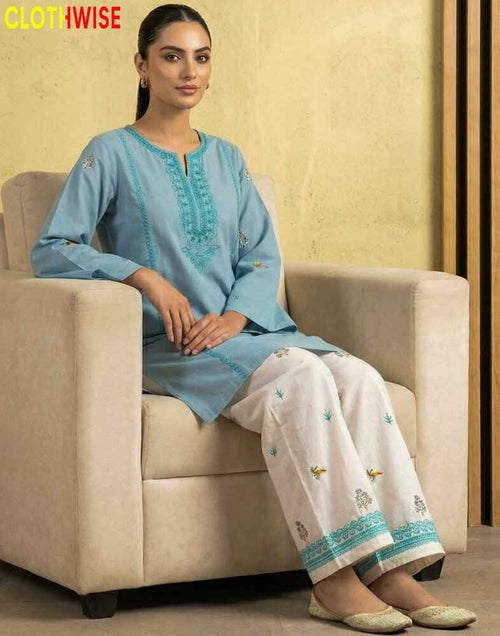 model wearing a embroidered suit sitting on sofa clothes by clothwise
