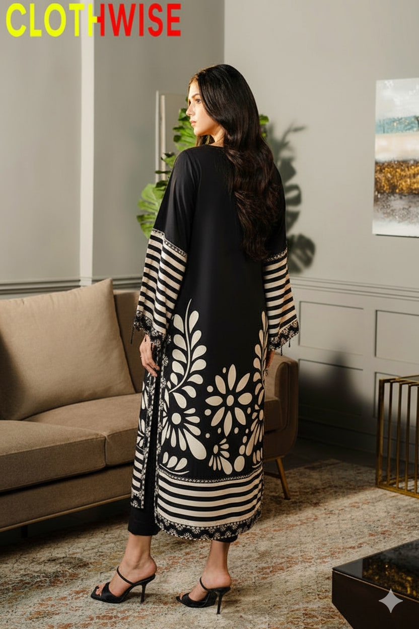 Woman wearing a black and white patterned dress in a living room setting.