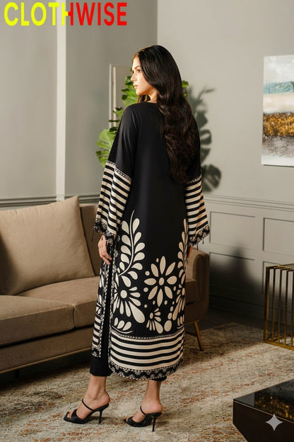 Woman wearing a black and white patterned dress in a living room setting.