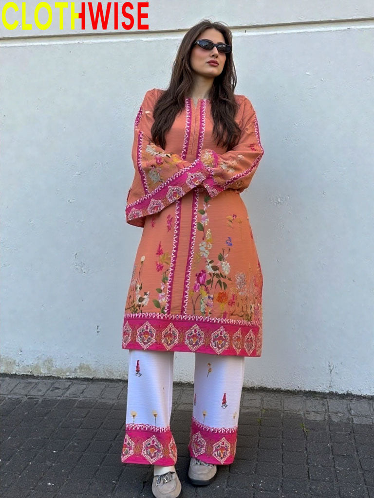Woman wearing a colorful embroidered outfit with 'CLOTHWISE' branding.