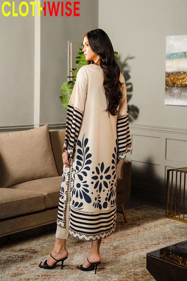 Woman wearing a long, patterned dress in a living room setting with 'CLOTHWISE' branding.