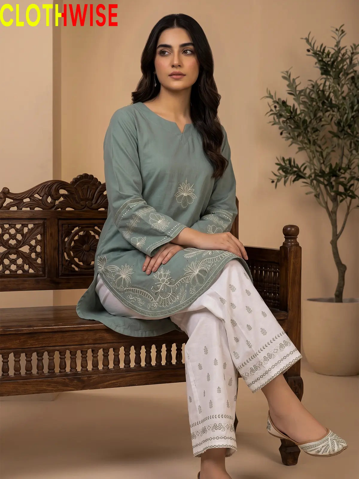 Petal sage green embroidered suit - sitting view showing flared bottom