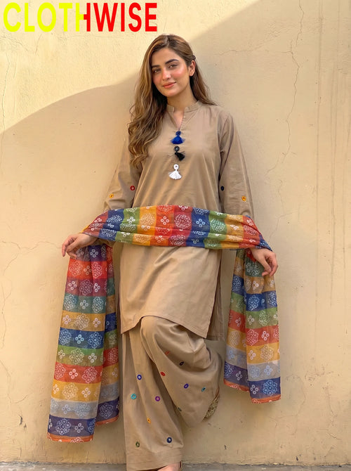Woman wearing a beige outfit with a colorful scarf, standing against a plain wall with 'CLOTHWISE' branding.
