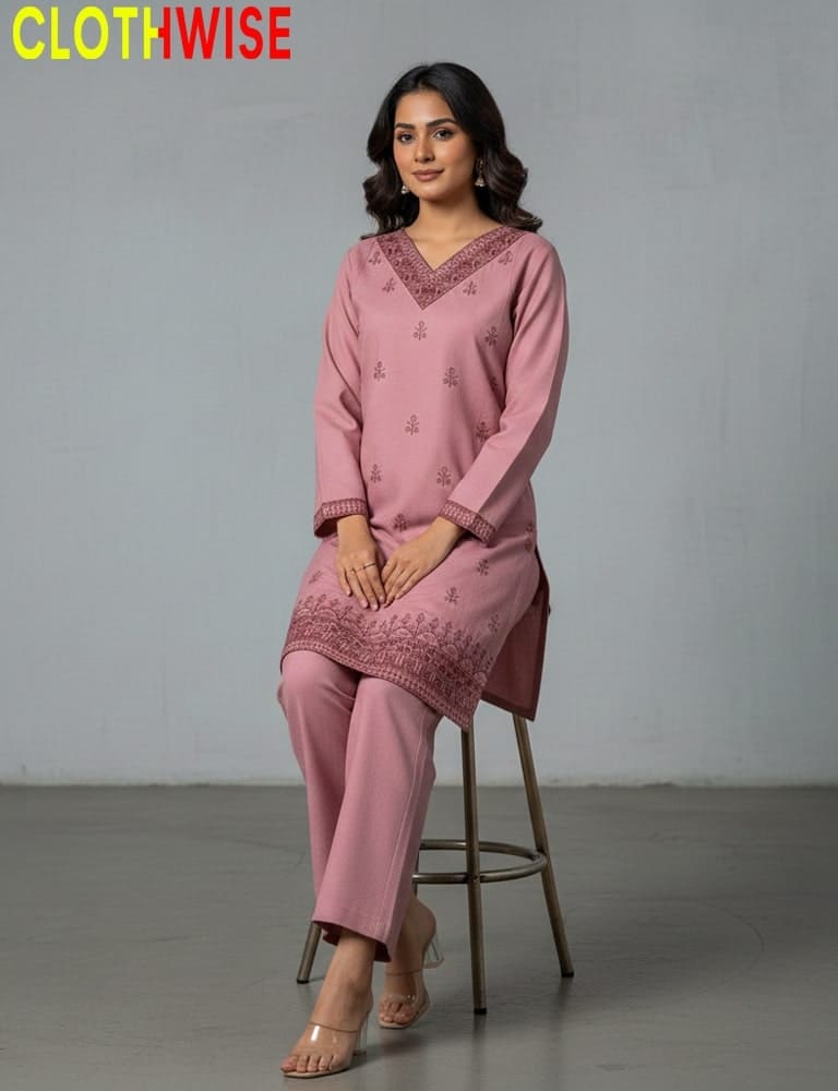 Woman in a pink traditional outfit sitting on a stool with 'ClothWise' branding.