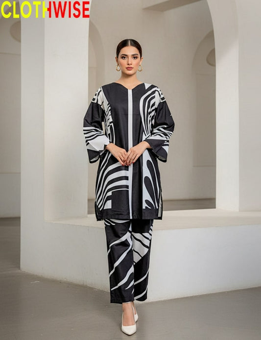 Woman wearing a black and white patterned outfit in a minimalistic setting with 'CLOTHWISE' branding.