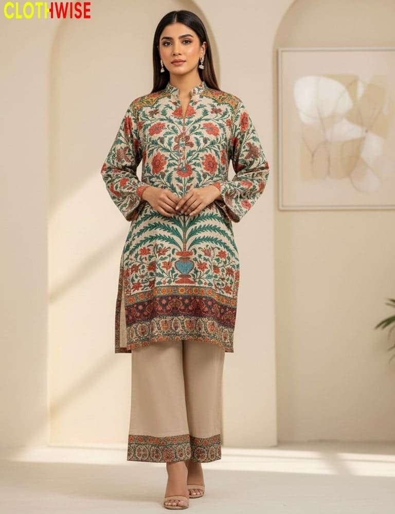 Woman wearing a patterned kurta with beige pants in a minimalistic room.