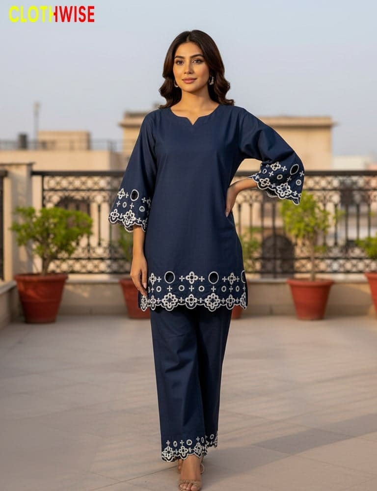 Woman wearing a navy blue outfit with white patterns on a rooftop.
