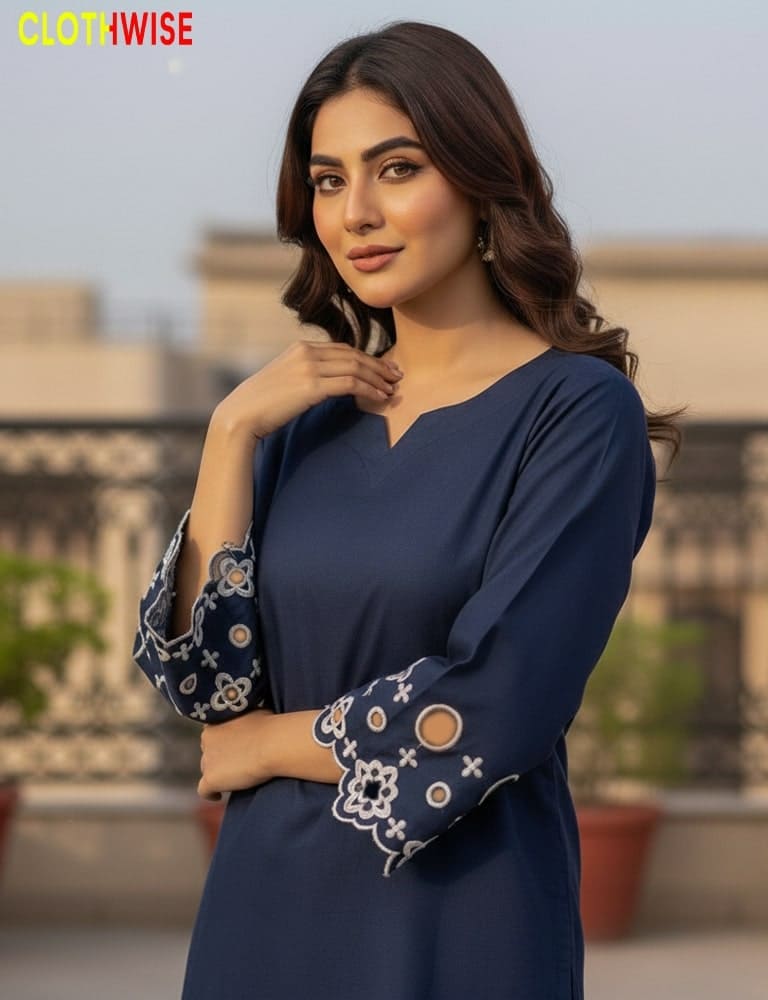 Woman wearing a blue dress with floral cuffs, standing outdoors.