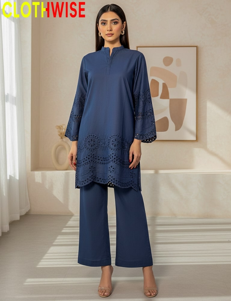 Woman wearing a blue outfit with intricate designs in a room with a painting on the wall.