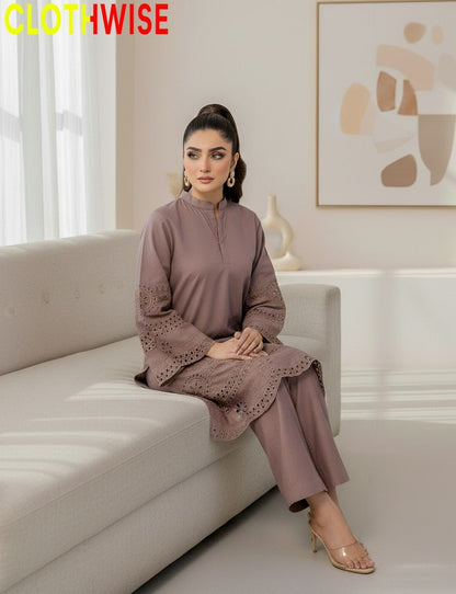 Woman sitting on a couch wearing a matching outfit with 'CLOTHWISE' branding.