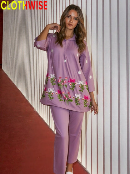 Woman wearing a purple embroidered outfit with 'CLOTHWISE' branding.