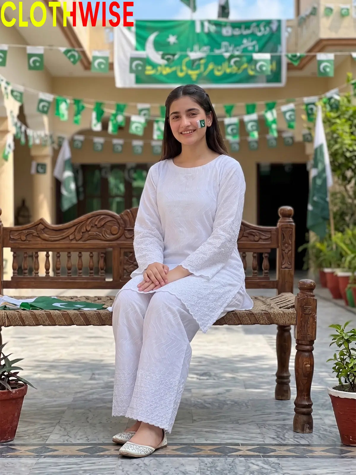 Model sitting in Azadi Chikankari Embroidered 2-piece lawn suit