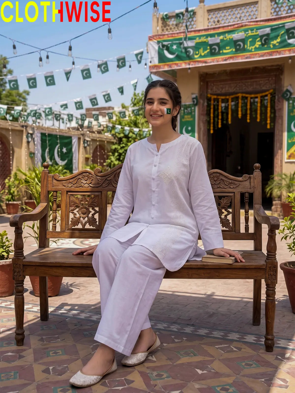 Model sitting in Azadi White One Side Embroidered 2-piece lawn suit