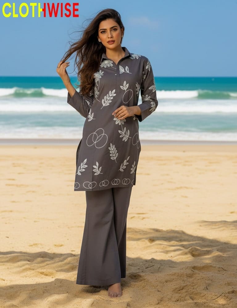 Woman in a gray patterned outfit standing on a beach with 'CLOTHWISE' branding.
