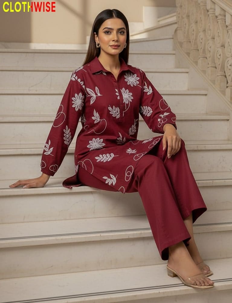 Woman in a maroon floral outfit sitting on stairs with 'Clothwise' branding.