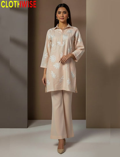 Woman wearing a beige floral outfit with 'CLOTHWISE' branding.