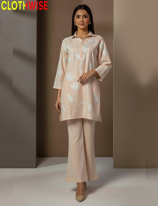 Woman wearing a beige floral outfit with 'CLOTHWISE' branding.