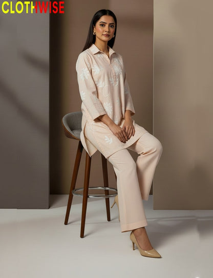 Woman in a beige outfit sitting on a stool with 'CLOTHWISE' branding.