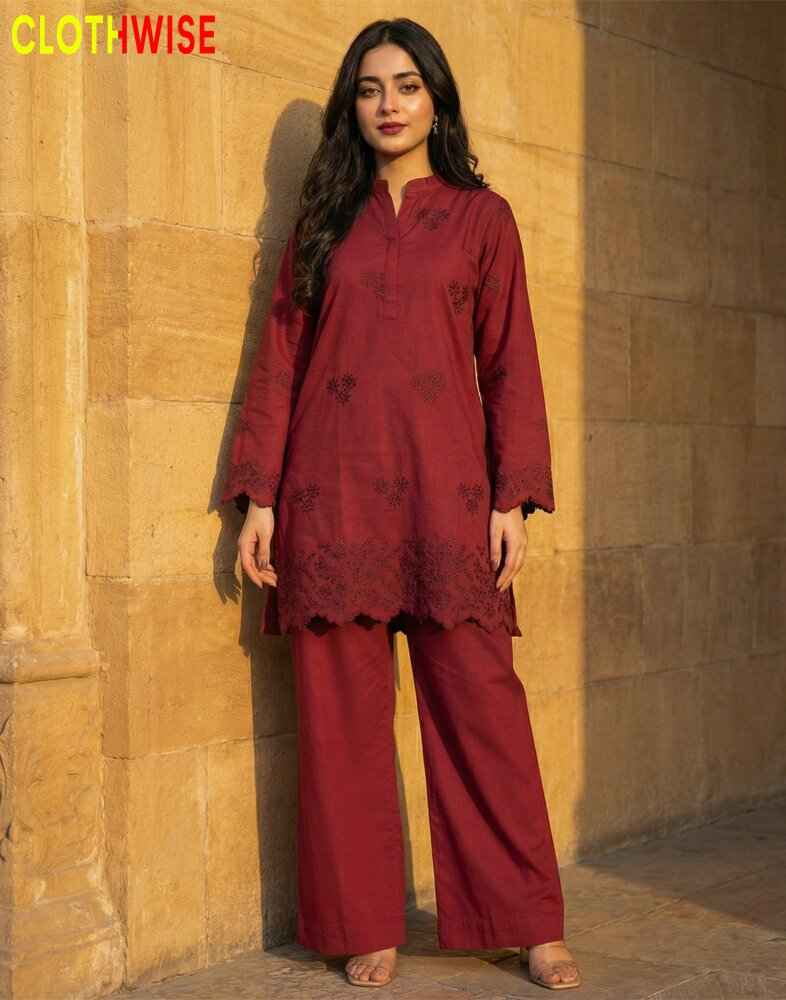 Woman wearing a maroon traditional outfit against a beige wall, with 'ClothWise' branding.