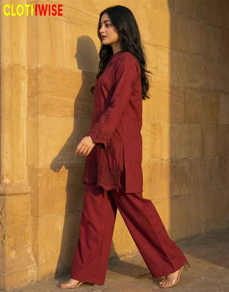 Woman in a red outfit standing against a textured wall with 'ClothWise' branding.